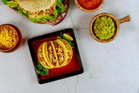 Stuffed taco shells with salsa and guacamole, mexican dish tacos. Stock Photos