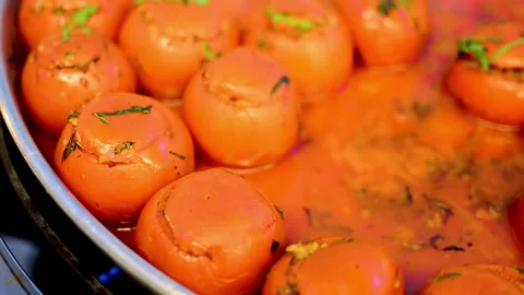 Stuffed tomatoes covered with herbs during baking time. Видео 152956751