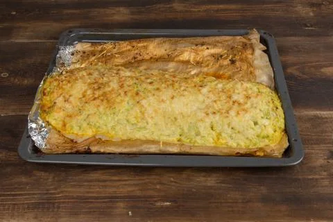 Stuffed zucchini on a baking sheet Stock Photos