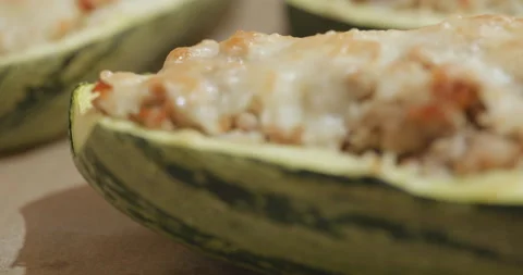 Stuffed zucchini in focus as camera pulls back Video stock 312370945