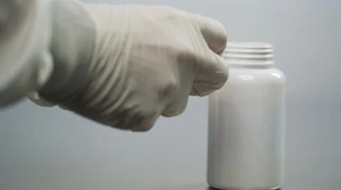 Stuffing bottles with cotton for packaging Stock Footage 50030112