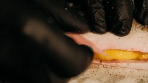 Stuffing fish with lemon Stock Footage 125458594