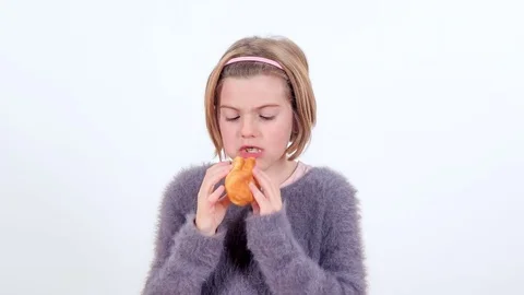 Stuffing her face with a lot of bread Stock Footage 83724842