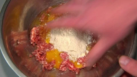 Stuffing mix with hand in a plate Stock Footage 72471717