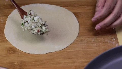 Stuffing vegetable mixture within two flat bread to make a paratha. Stock Footage 128777698