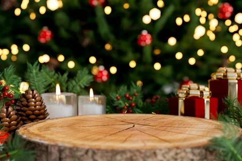 Stump wooden table with present gift box aside candle and pinecone in front.. Stock Illustration