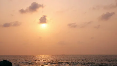 A stunning 4K time-lapse of a golden sunset over the ocean. Stock Footage 341554476