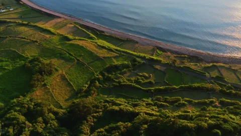 Stunning aerial drone high-angle shot of a picturesque ocean bay at golden hour Stockbeeldmateriaal 335710511