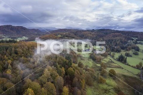 Stunning aerial drone landscape image from in the clouds looking down on hill Stock Photos