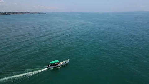 Stunning aerial drone shot capturing a fisher boat in the middle of the tranquil Stock Footage 297596413