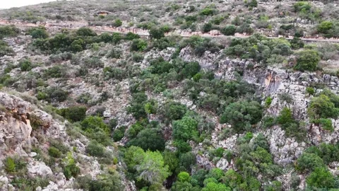 A stunning aerial drone view of a mountain and road Stock Footage 296589274