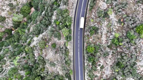 A stunning aerial drone view of a mountain and road 스톡 동영상 296589278