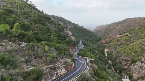 A stunning aerial drone view of a mountain and road Stock Footage 296589290