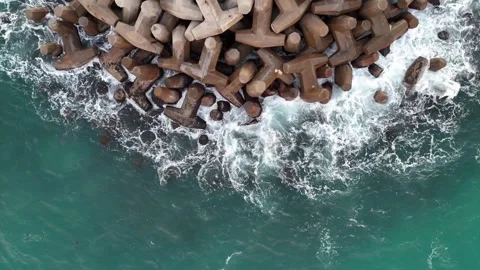A stunning aerial drone view of waves crashing against rocks Stock Footage 296176731