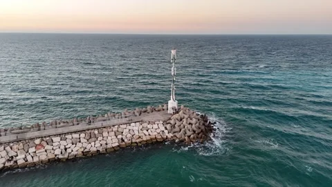 A stunning aerial drone view of waves crashing against rocks Stock Footage 296176808
