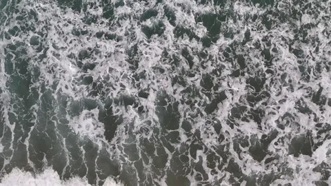 A stunning aerial drone view of waves crashing against rocks Stock Footage 296177418