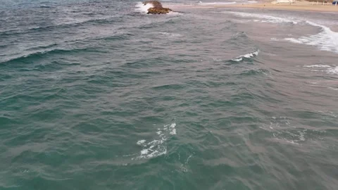 A stunning aerial drone view of waves crashing against rocks Video stock 296177537