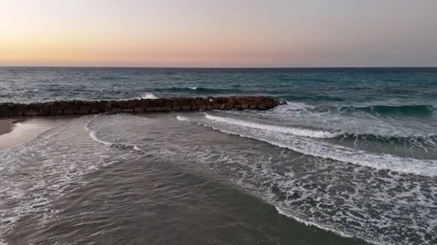 A stunning aerial drone view of waves crashing against rocks Stock-Footage 296177890