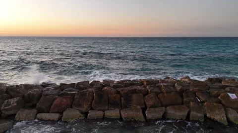 A stunning aerial drone view of waves crashing against rocks Stock Footage 296178133