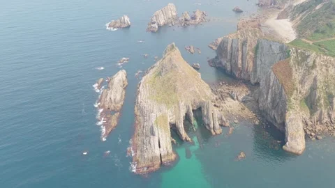 Stunning aerial footage showcasing dramatic rocky cliffs and coastal formations Stock Footage 346712149