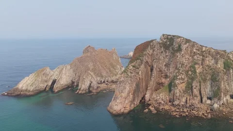 A stunning aerial shot captures the dramatic rocky cliffs and turquoise waters Stock Footage 346718753