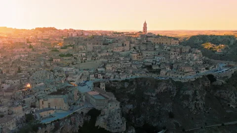 Stunning aerial sunset view over Sassi di Matera Old Town with cave dwellings. Stock Footage 240922103