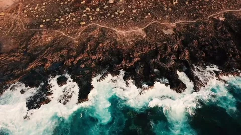 Stunning aerial top-down view of turquoise ocean waves breaking Stock Footage 344396296