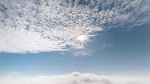 Stunning aerial view above thick white clouds with bright sun shining in bl.. Stock Footage 339347405