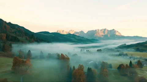 Stunning aerial view of austrian alpine valley filled with morning fog. Stock-Footage 341389820
