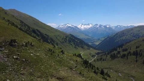 Stunning Aerial View of the Austrian Alps with Snowy Peaks and Green Summer.. Stock Footage 333628052