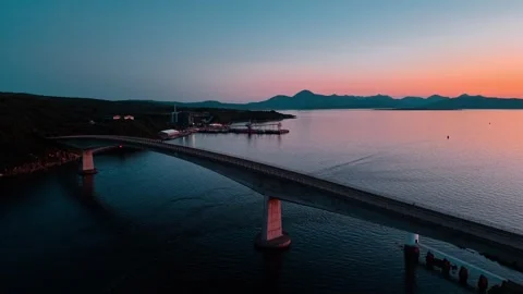 Stunning aerial view of a bridge over calm waters in Scotland at sunset Stock Footage 313999768