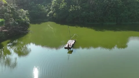 Stunning Aerial View of Calm River with Fisherman Working on the Raft Stock Footage 309918766