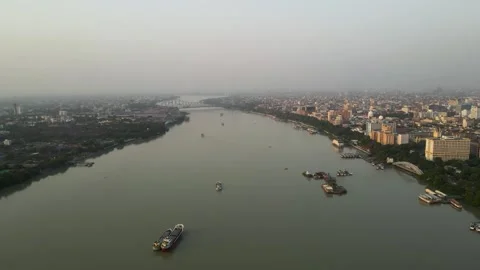 Stunning aerial view of the iconic Howrah Bridge over the serene waters of the Stock Footage 299214432