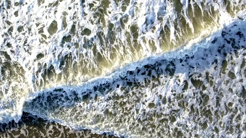 A stunning aerial view showcasing the mesmerizing ocean waves along with foamy Stock Footage 291290853