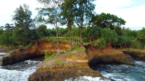 Stunning aerial view of towering cliffs by Bengkulu beach Stock Footage 289404184