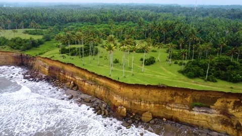Stunning aerial view of towering cliffs by Bengkulu beach Stock Footage 289404368