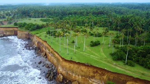 Stunning aerial view of towering cliffs by Bengkulu beach Stock Footage 289404373