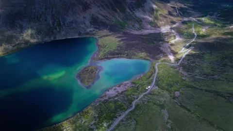 Stunning Aerial View of Turquoise Mountain Lake and Winding Road China 動画素材 346737829