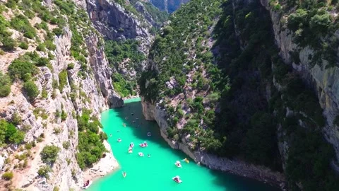 Stunning Aerial View of Turquoise River in Scenic Canyon with Boats Stock Footage 317499272
