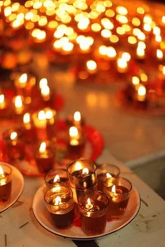 Stunning array of glowing candles forming rows and casting warm light, idea.. Stock Photos