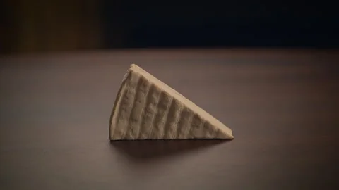 A Stunning Artistic Presentation of a Classic Triangular Piece of Cheese on Stock Footage 293640278