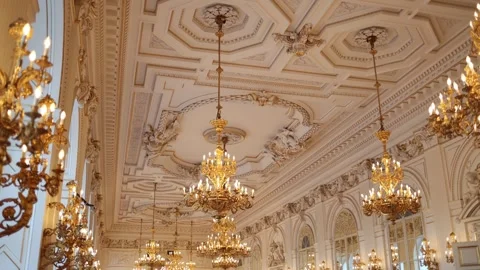 A stunning ballroom with an intricately designed ceiling adorned with golden cha Stock Footage 294771434