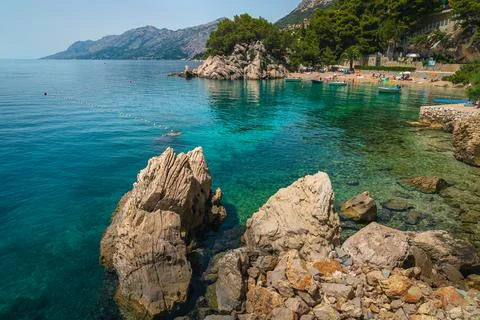 Stunning beach and moored boats in Dalmatia, Brela, Croatia Stock Photos