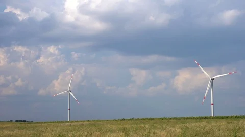 Stunning blue clouds in rain sky over wind power energy saving source turbine Stock Footage 95318983