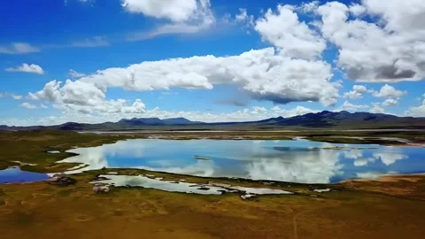 Stunning Blue Lake Reflecting Sky and Clouds Qinghai Tibet Plateau China Stock Footage 339513640