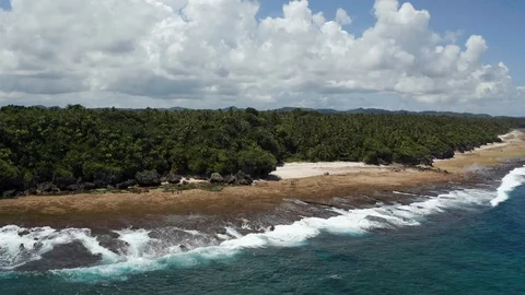 Stunning blue ocean and waves crash at Siargao rock pools 4K Drone Footage Stock Footage 102870598