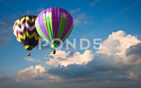 Stunning blue sky cloud formations with hot air balloons Stock Photos