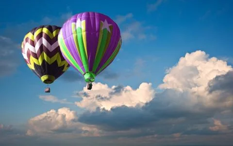 Stunning blue sky cloud formations with hot air balloons Stock Photos