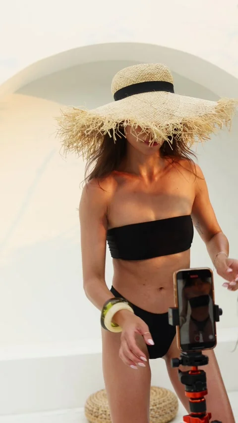 Stunning brunette model posing in bikini against white backdrop Stock Footage 312802030