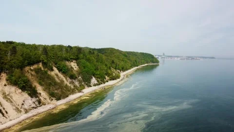A stunning cliffside beach with lush greenery, evoking a serene atmosphere Stock Footage 280124382